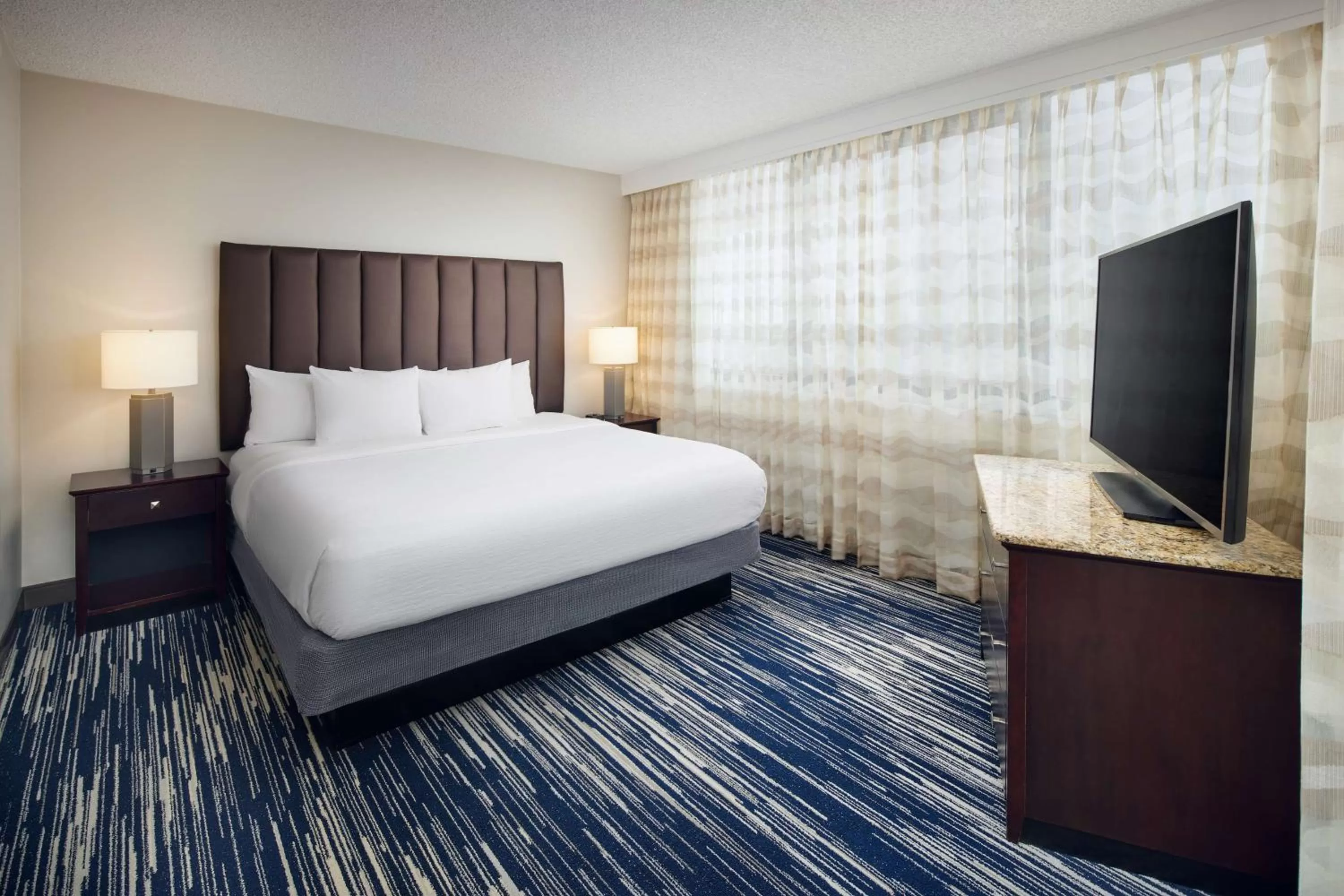 Two-Room Corner King Suite with One King Bed and Sleeper Sofa - Balcony in Embassy Suites by Hilton West Palm Beach Central