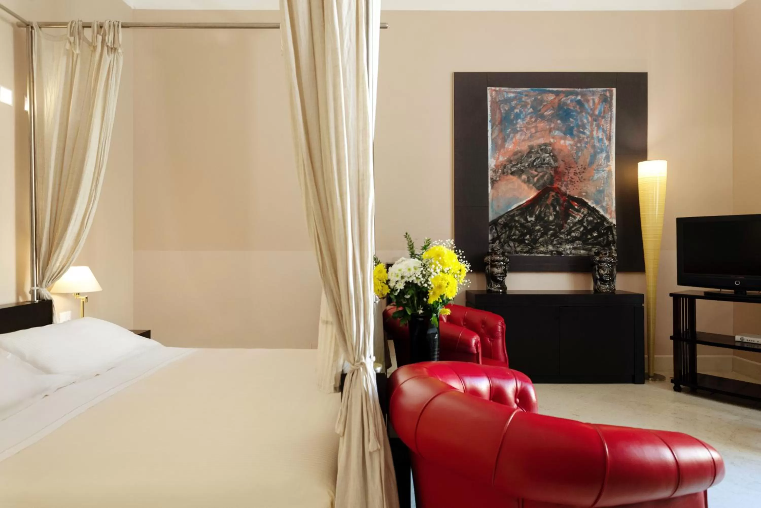 Superior room with a four poster bed in Palazzo Brunaccini Boutique Hotel