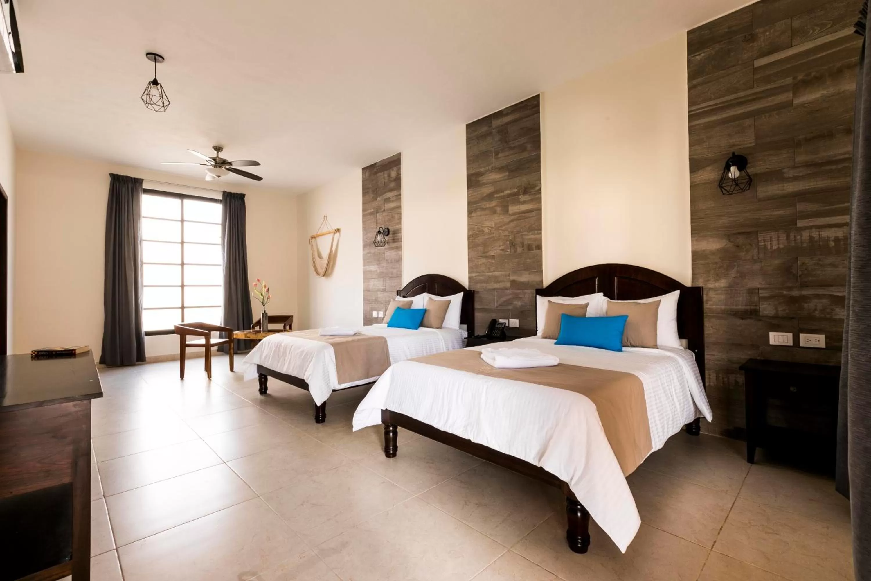 Junior Suite 1 king size bed and 1 double bed, living room, pool and garden view in Hotel Los Frailes, Valladolid, Yucatán