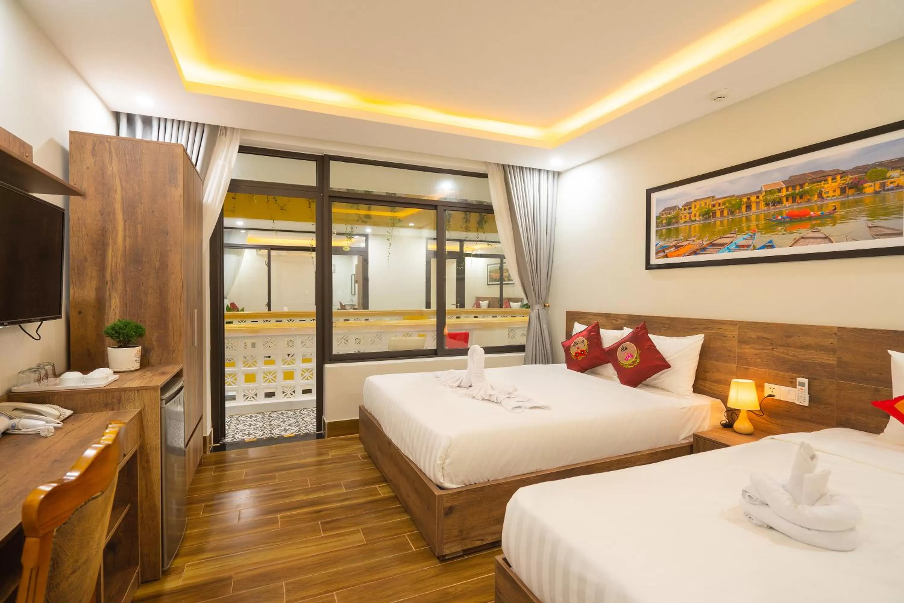DELUXE TRIPLE ROOM WITH BALCONY AND POOL VIEW in The Lit Villa Hoi An