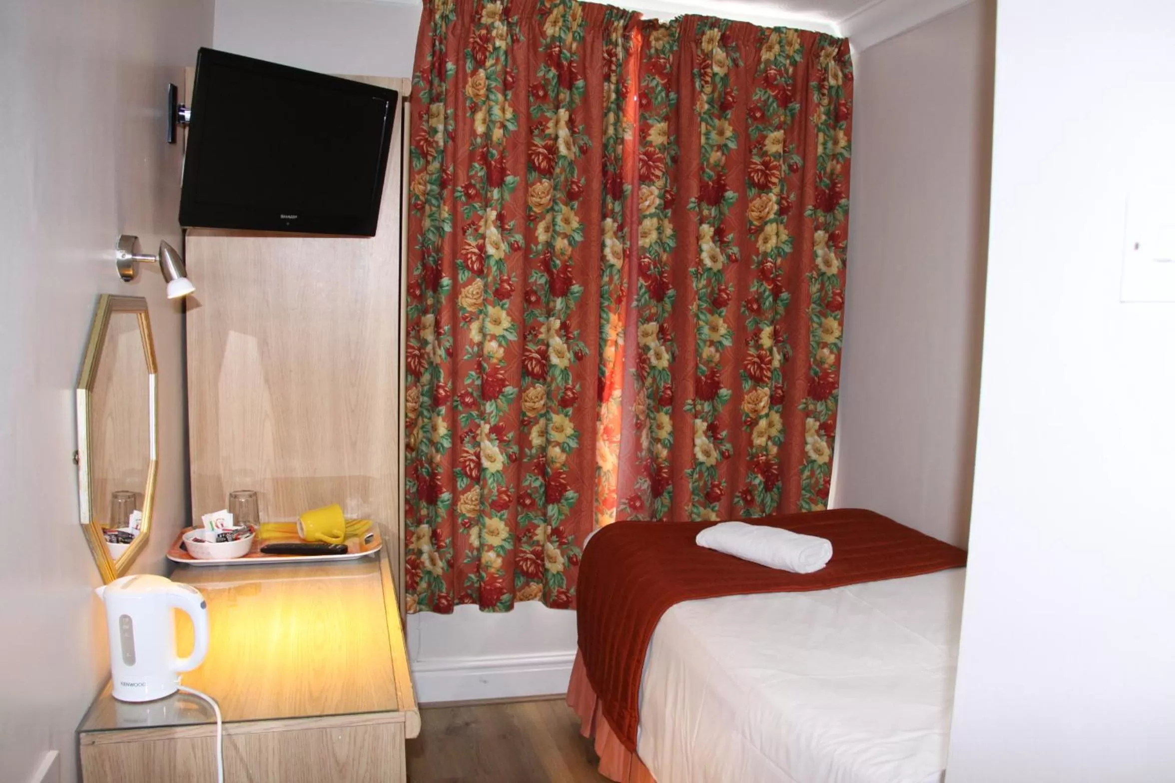 Bed in Ambassador Hotel