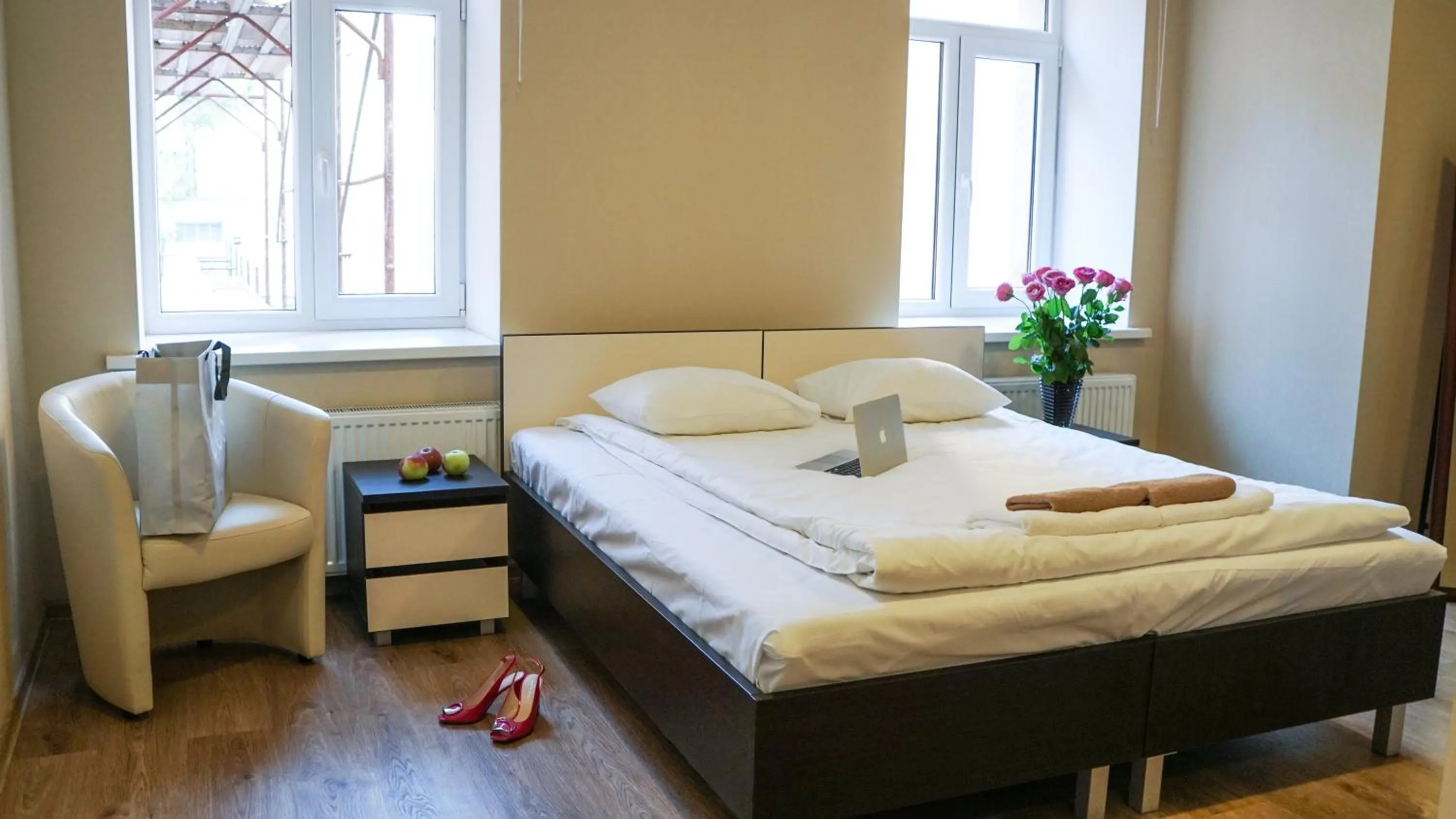 Superior Quadruple Room with one king size and two single beds and lounge area in Bella Riga Hotel with Self-Check in