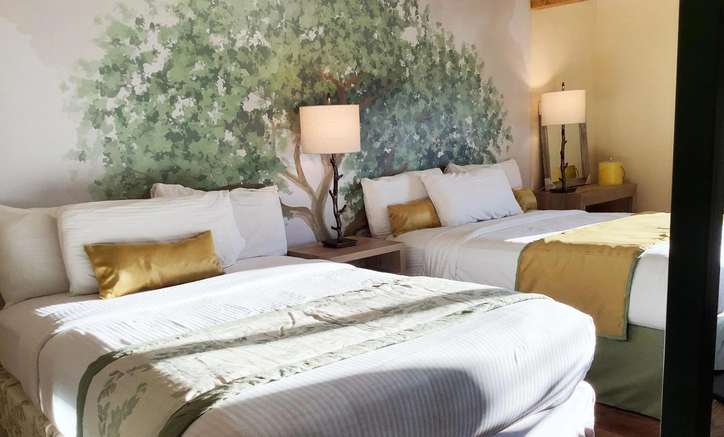 Superior Double Queen Room with Parkway View Shared Balcony with Rocking Chairs in Arbors at Island Landing Hotel & Suites