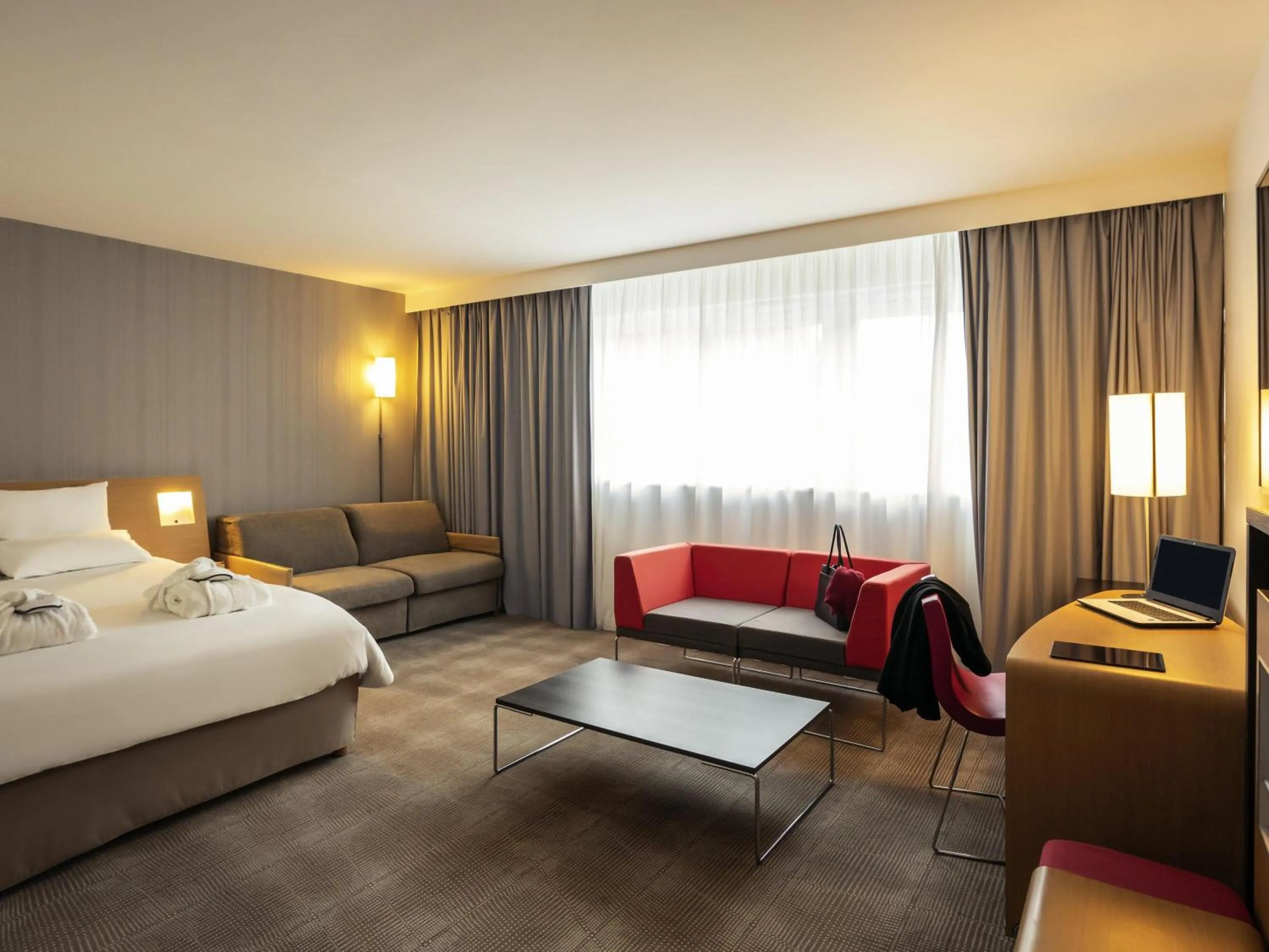 Standard Suite with 1 double bed and 2 sofas in Novotel Roissy Saint Witz