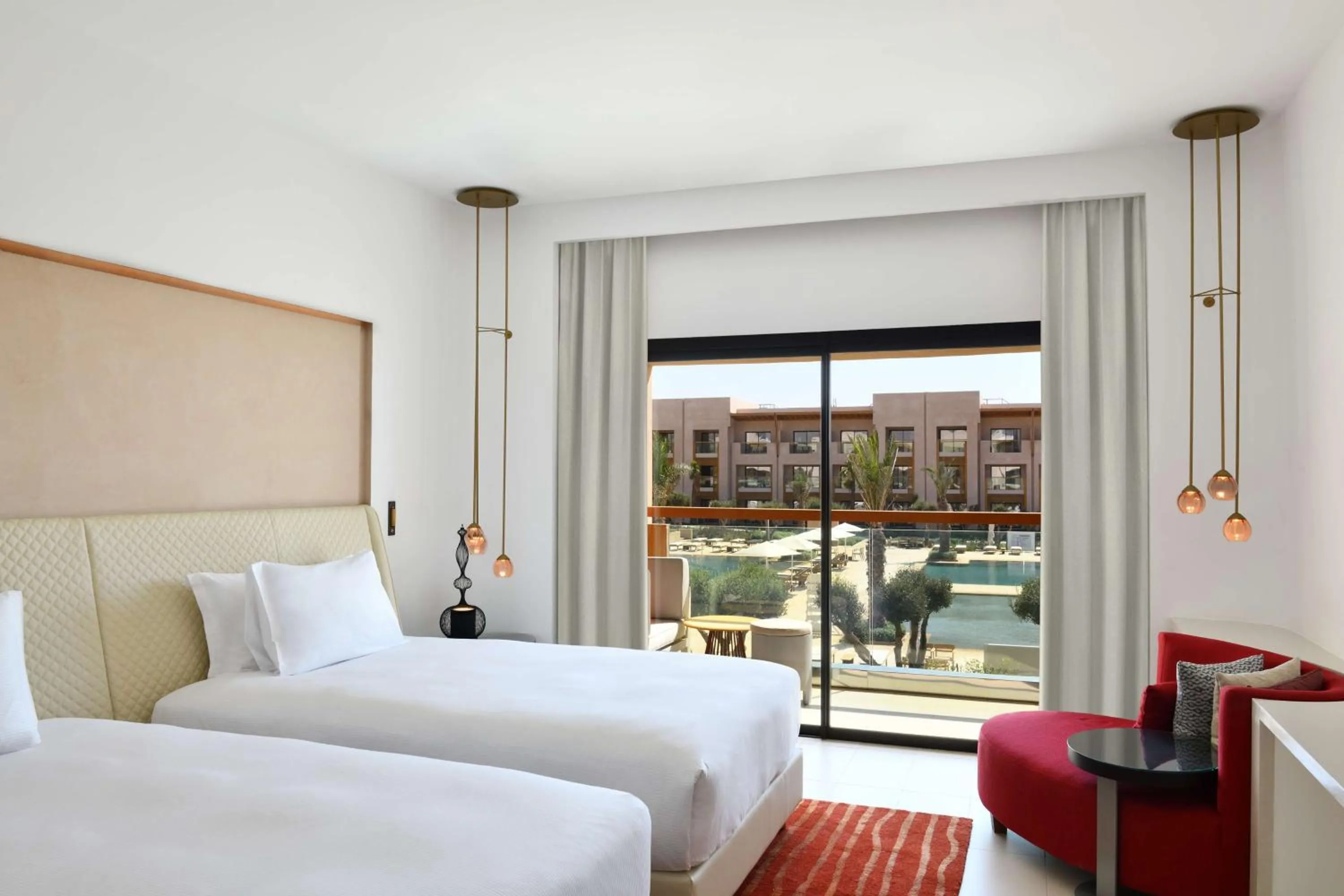 Guest Room with Two Double Beds and Pool View in Hilton Taghazout Bay Beach Resort & Spa
